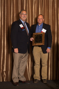 Dr. Bob Broida [left] receives the Bill Hall Award from Dr. Bill Reisinger, who nominated the honoree