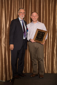 Dr. John Lyman presents Dr. Gary Katz [right] with the Emergency Physician Leadership Award